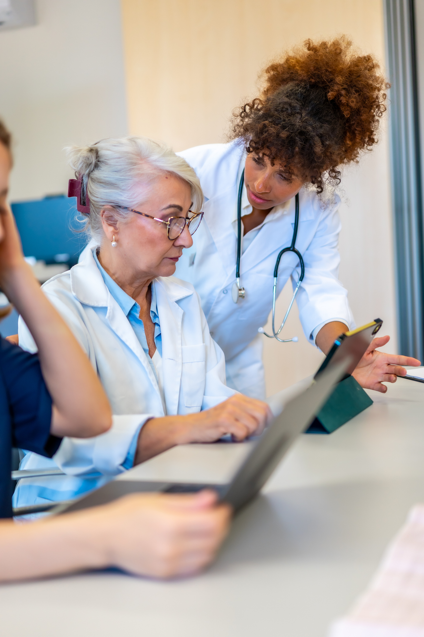 Clinical team reviewing patient information together on a tablet